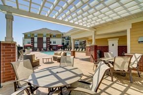 Sun Prairie apartment for rent - a patio with tables and chairs and a swimming pool